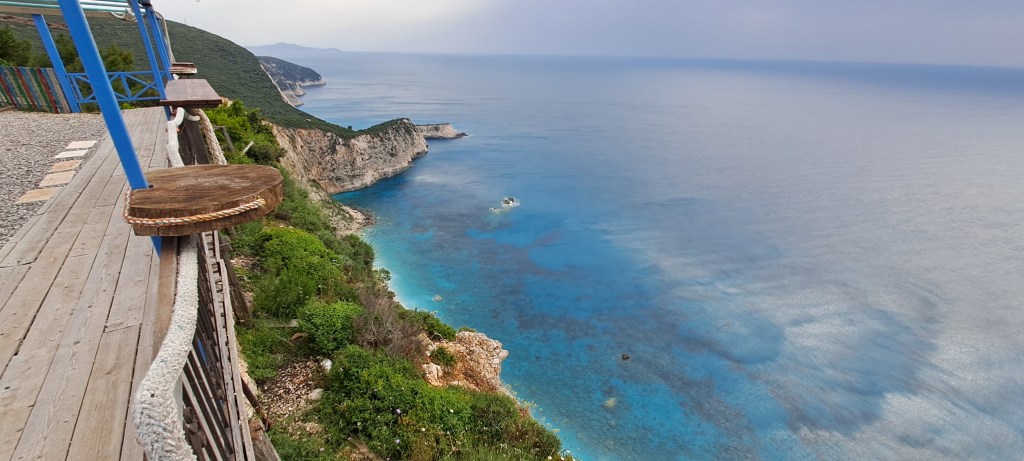 The forest and white rocks cliffs on the west coast of Lefkada island Greece before Porto Katsiki beach ending in the crystal clear blue Ionian sea